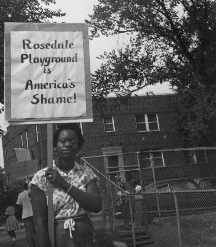 A Protester holds a sign reading "Rosedale Playground is America's Shame" -1952